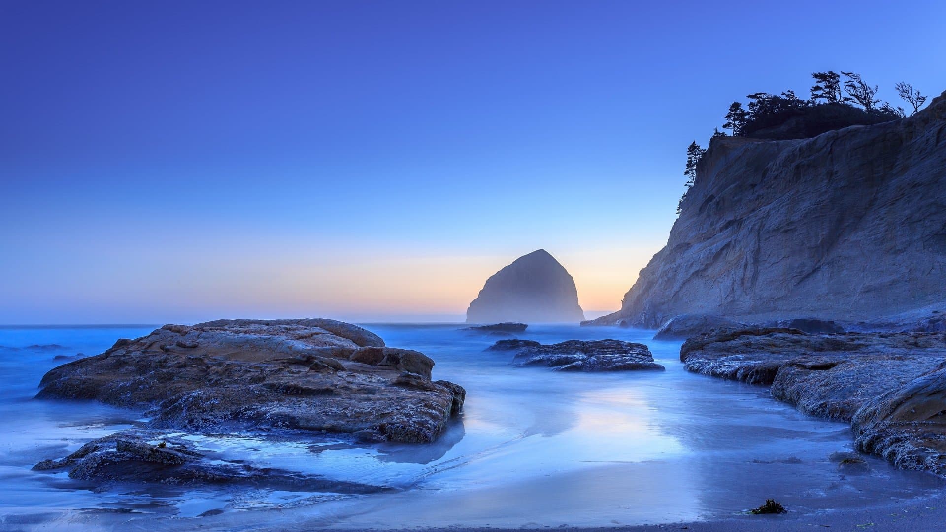 Dramatic blue coastline at dusk for a private luxury yacht itinerary
