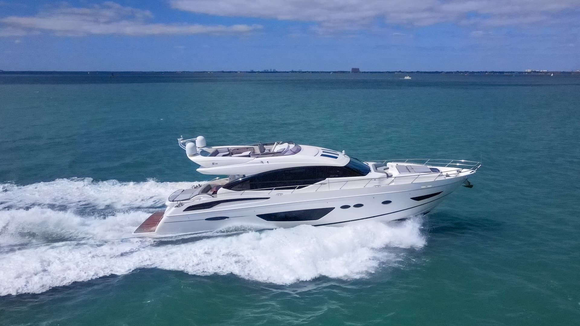 Luxury private yacht cruising through clear blue water on a kosher charter