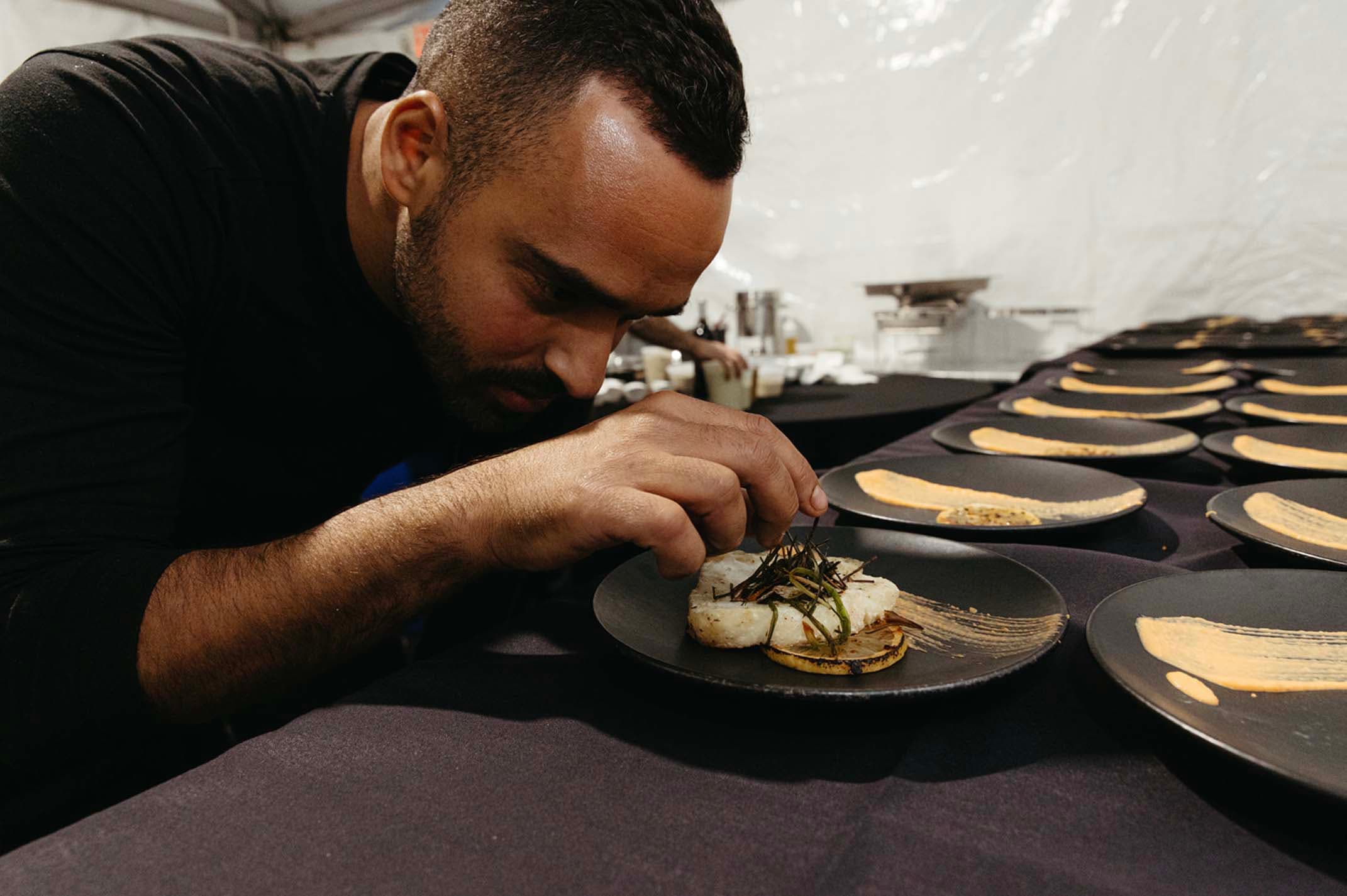 Kosher private chef carefully plating a fine dining course