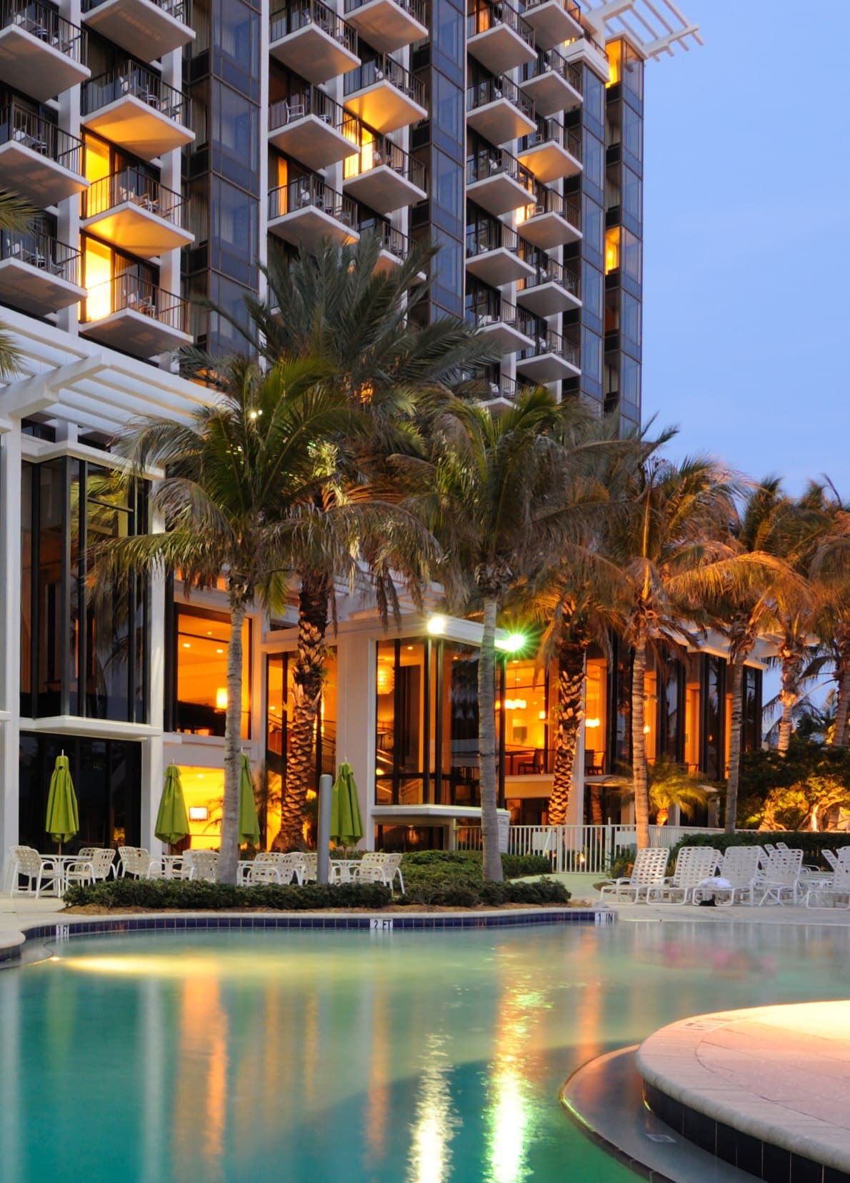 Luxury oceanfront hotel and resort with a palm-lined pool